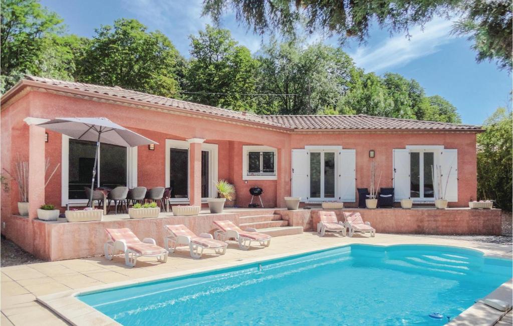 a villa with a swimming pool and a house at Gorgeous Home In Bédarieux in Bédarieux