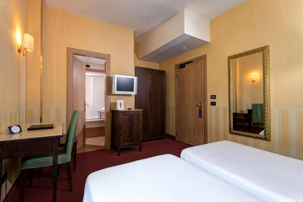 Postel nebo postele na pokoji v ubytování Best Western Hotel Tritone