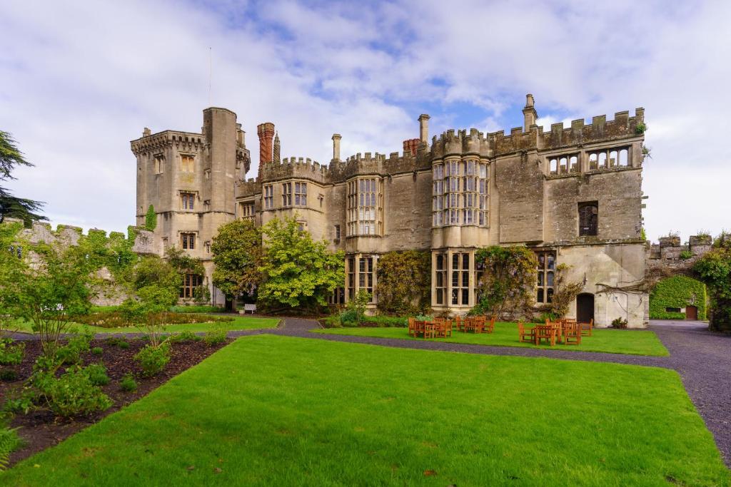 an old castle with a lawn in front of it at Thornbury Castle - A Relais & Chateaux Hotel in Thornbury