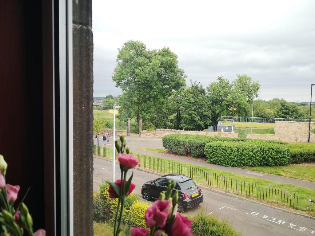 a view from a window of a car driving down a street at Forth View Apartment in Stirling