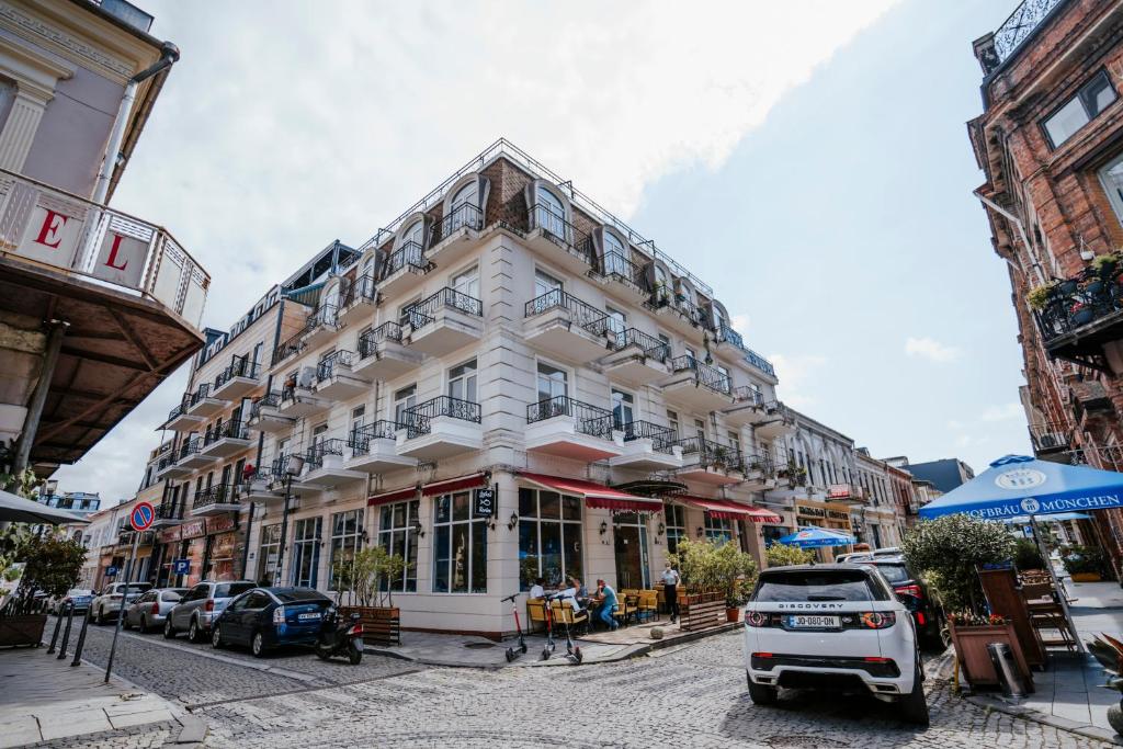 a large white building on a city street at West Apart Hotel in Batumi