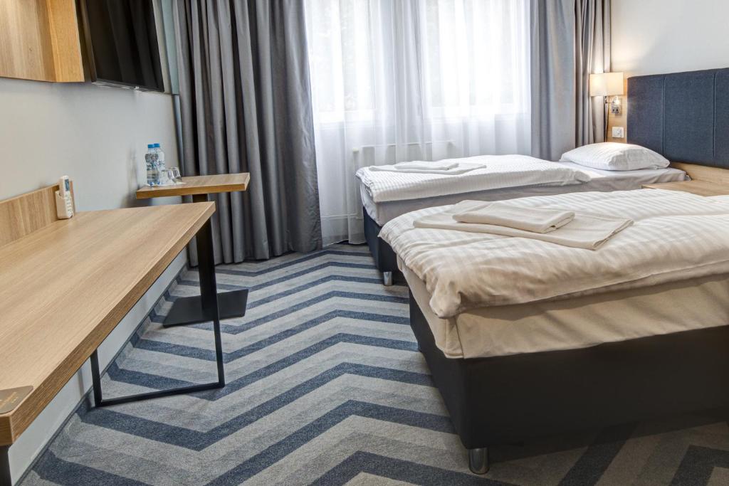 Postel nebo postele na pokoji v ubytování Hotel Dobosz