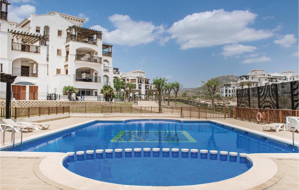 a large swimming pool in front of a building at Amazing Apartment In Baños Y Mendigo in Baños y Mendigo