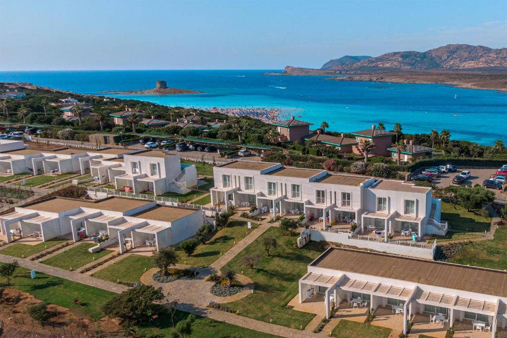 an aerial view of a house with the ocean at Capo Falcone Charming Apartments in Stintino