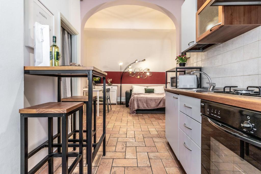 a kitchen with a counter and stools in a room at Wine Apartments Florence Ansonica in Florence