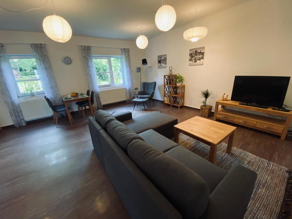 a living room with a couch and a flat screen tv at Haus Lavendel in Vinningen