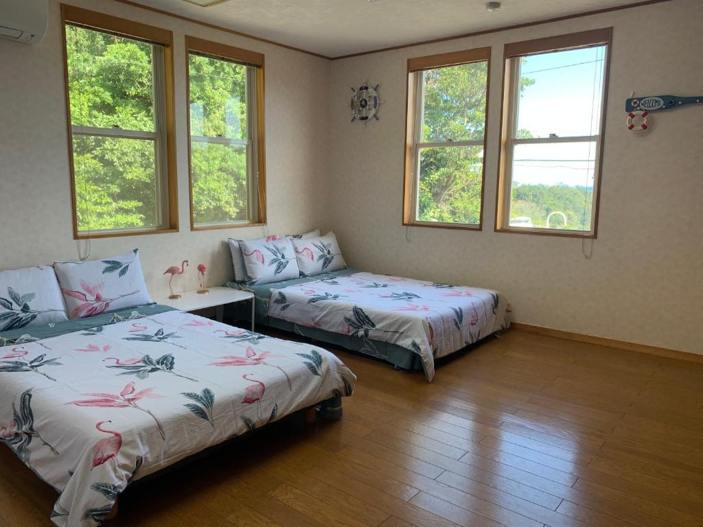 Postel nebo postele na pokoji v ubytování 半島の家