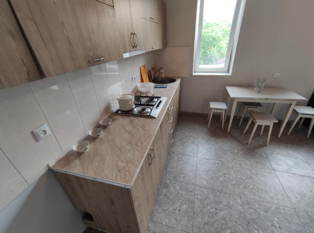 an overhead view of a kitchen with a counter and a table at Hostel on the river in Batumi