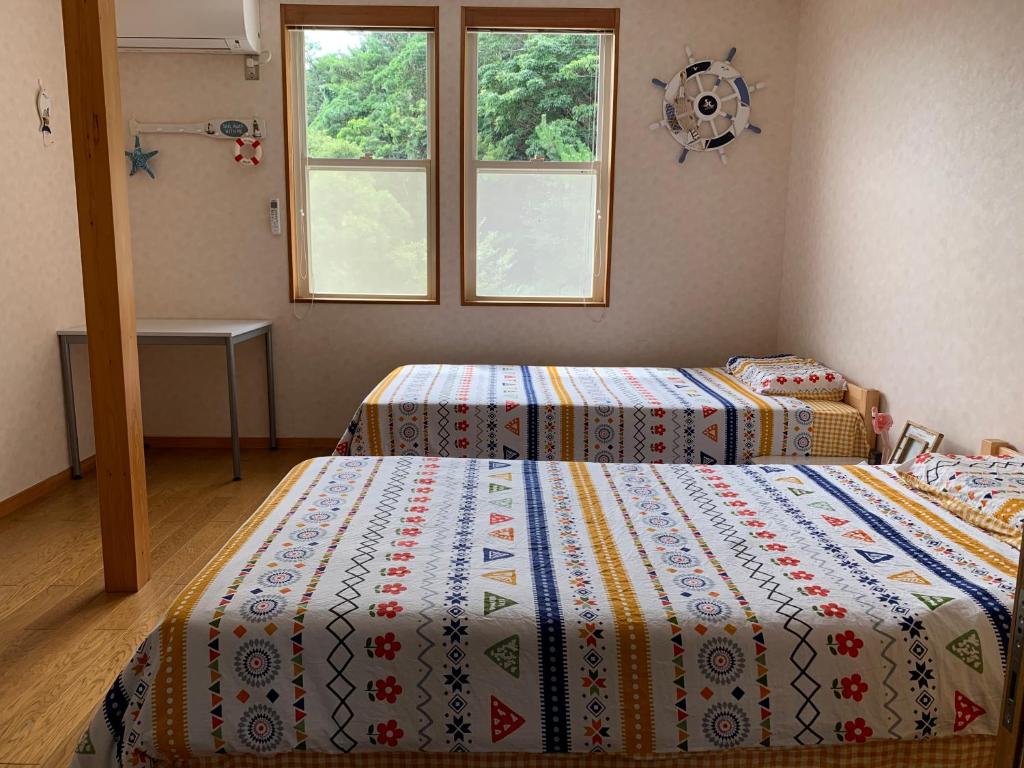 Postel nebo postele na pokoji v ubytování 半島の家