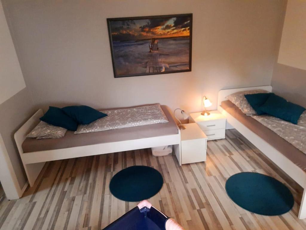 Kleines Zimmer mit 2 Betten und einem Tisch in der Unterkunft Gästezimmer An der Krückau in Elmshorn