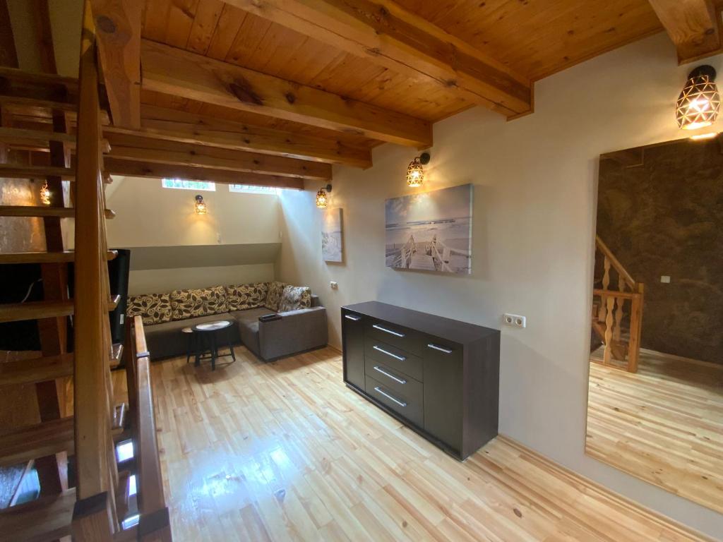 an overhead view of a living room with wooden floors at Bungalow Smiltele in Nida