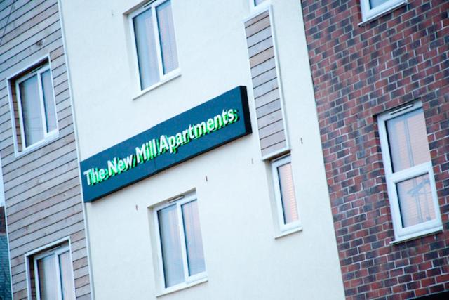 a sign on the side of a brick building at The New Mill Apartments in Newcastle upon Tyne