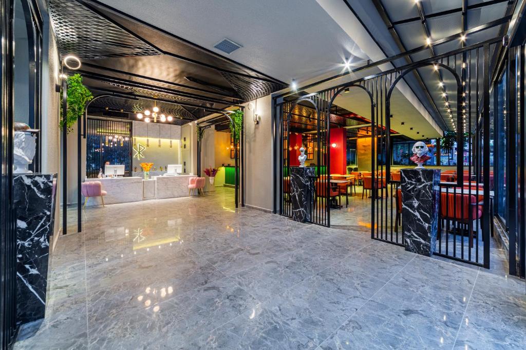 a lobby with a wrought iron gate and a dining area at Aria Riva Apart Hotel in Alanya