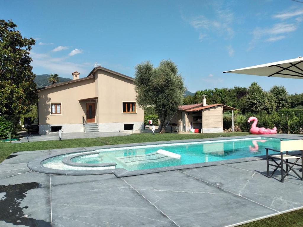 an image of a swimming pool in front of a house at Villa Elisa in Pietrasanta