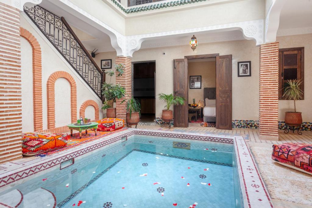 a large swimming pool in a large room with at Riad Salman in Marrakech