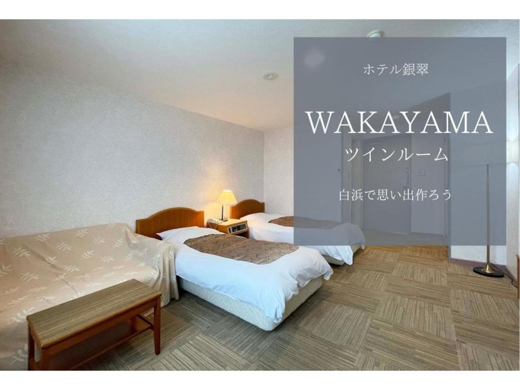 a hotel room with two beds and a sign on the wall at Hotel Ginsui - Vacation STAY 58202v in Kanayama