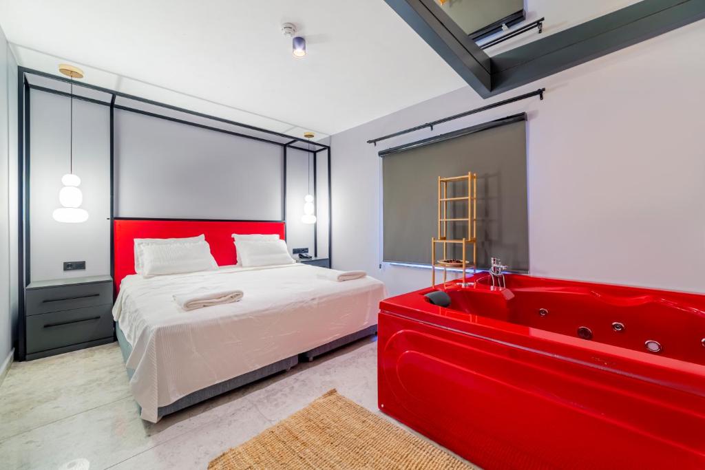 a bedroom with a red bed and a red bath tub at Aria Riva Apart Hotel in Alanya
