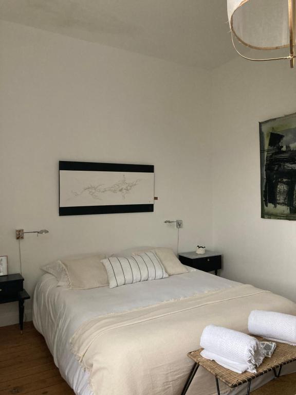 a bedroom with a large bed with two towels on it at la boutique mj décoration vous propose de découvrir ses deux chambres d'hôtes in Doué-la-Fontaine