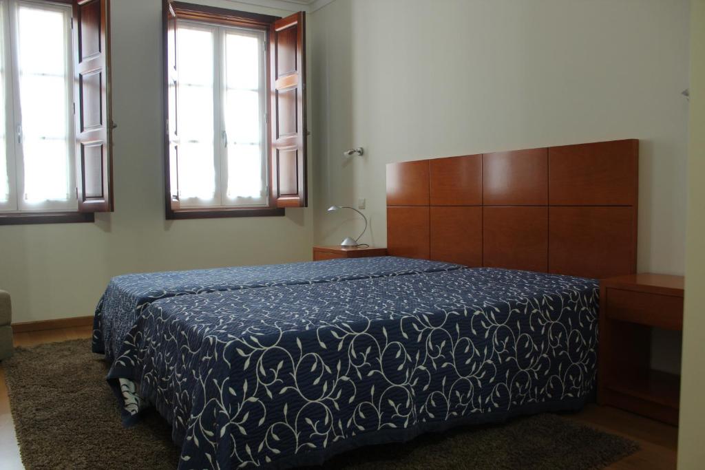 Postel nebo postele na pokoji v ubytování Guesthouse Muralhas do Mino