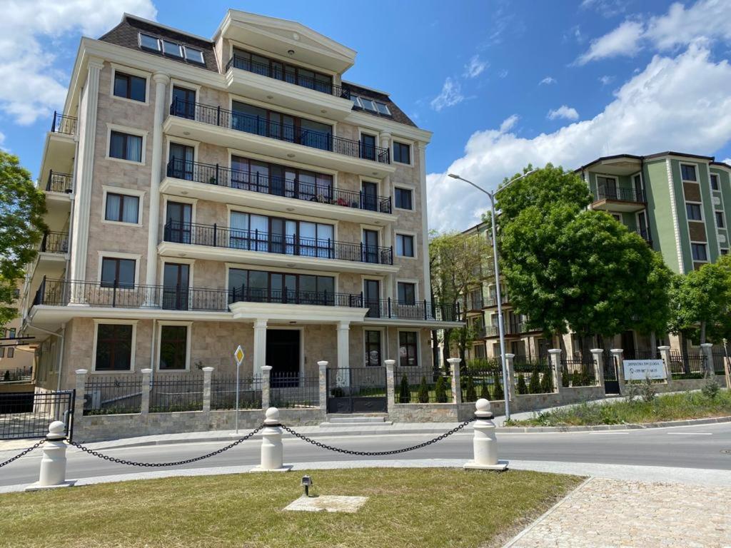 a building on a street with a fire hydrant in front at Rabi Park Residence in Varna City