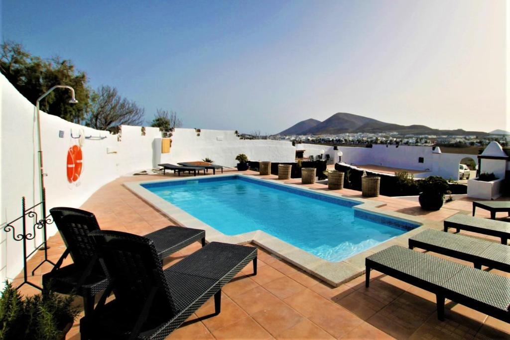 a swimming pool on the roof of a building at Casa Natura 23 in San Bartolomé