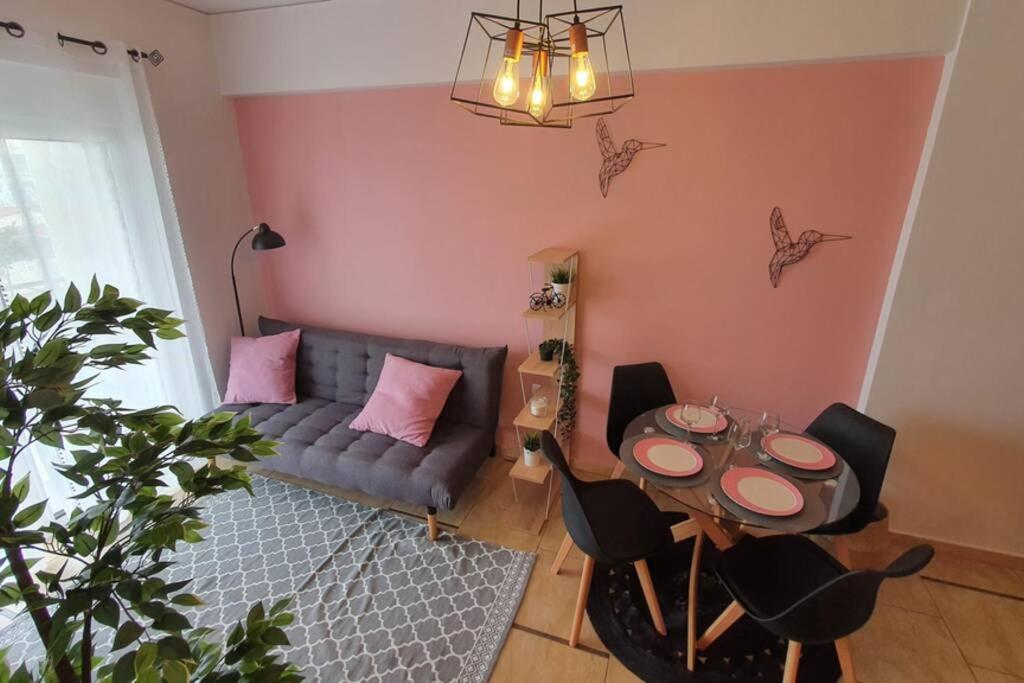 a living room with a couch and a table at Vasilikis design appartment in Amalias