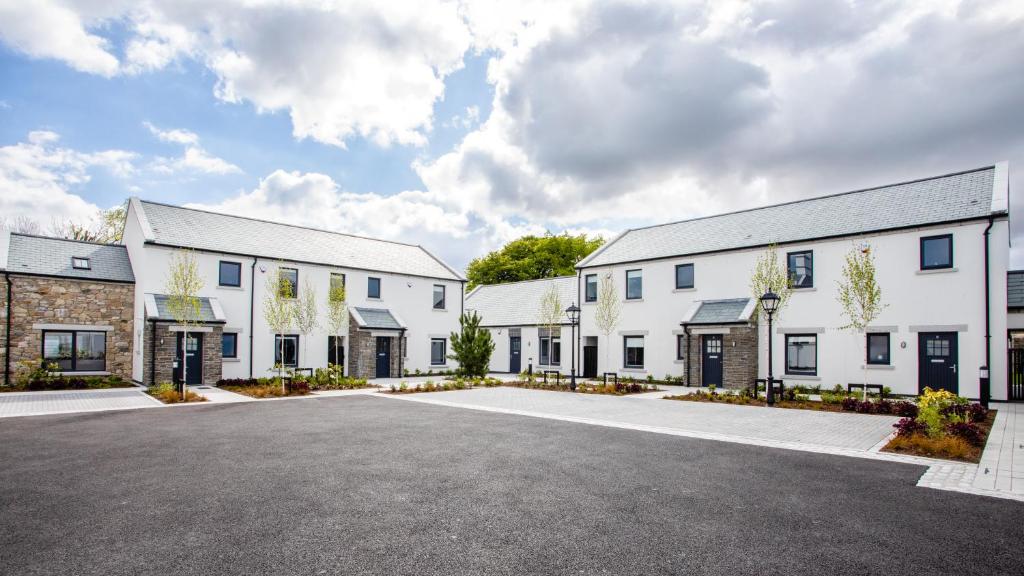 a row of white buildings with a parking lot at Hilltown Lodges No4 in Hilltown