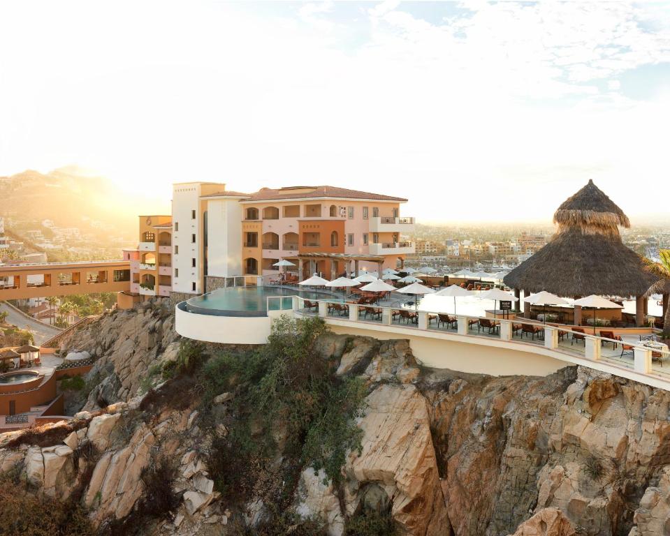 a building on top of a rocky mountain at The Ridge at Playa Grande in Cabo San Lucas