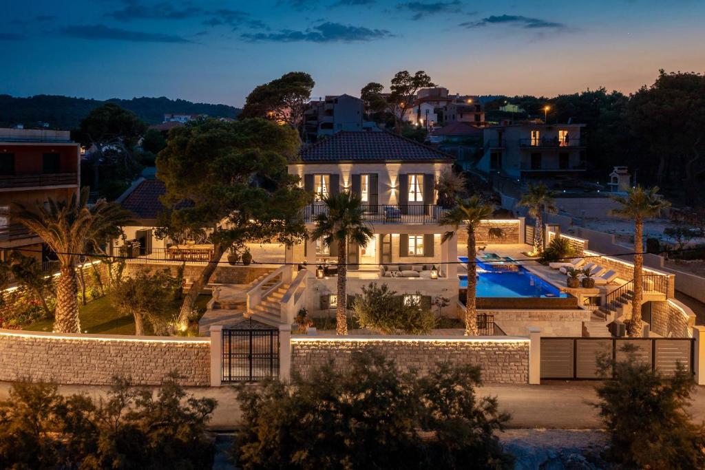 a mansion with a swimming pool at night at Villa L'orizzonte in Slatine