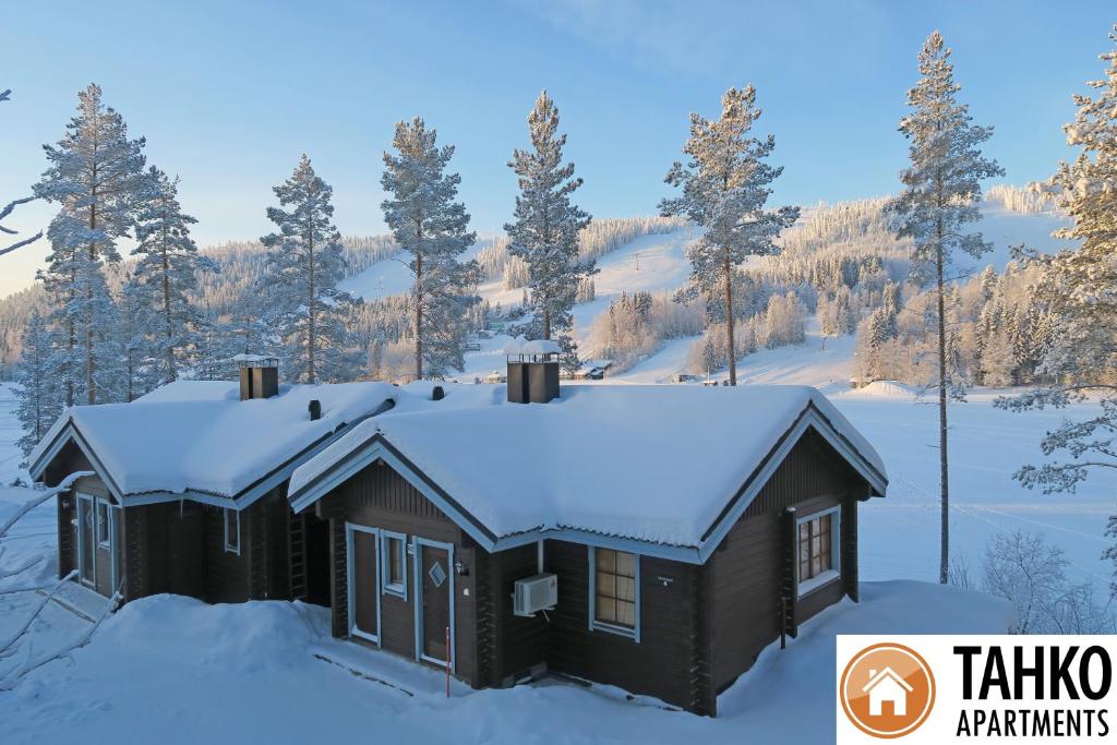 a house with snow on the roof at Villa Ozero in Tahkovuori