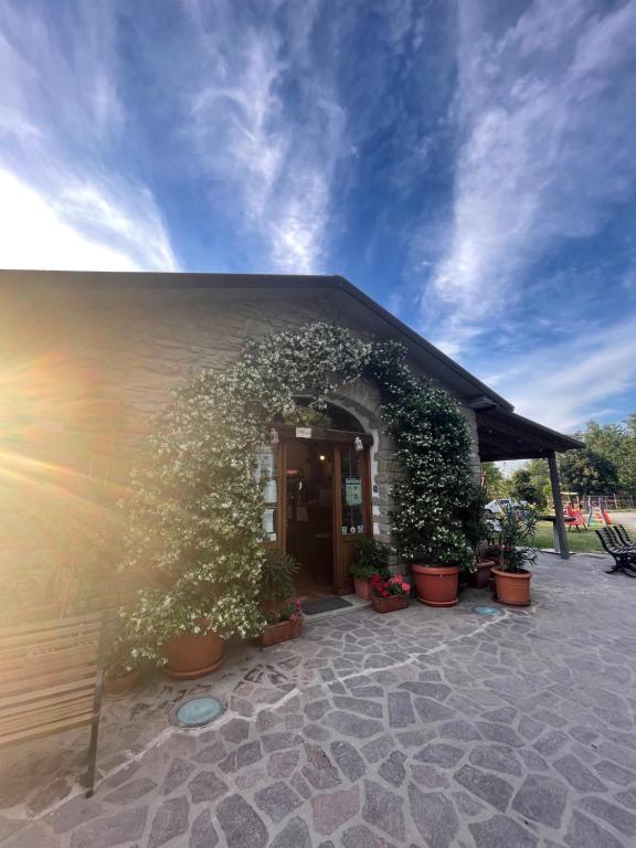 a building with potted plants in front of it at Agriturismo La Fine in Piancaldoli