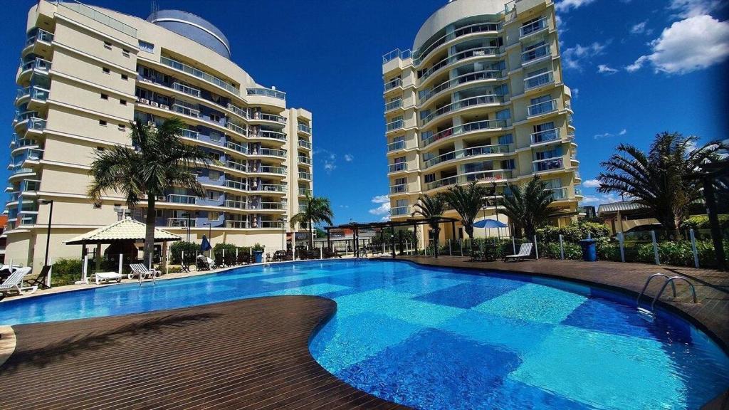a swimming pool in front of two tall buildings at Apartamento Nautilus + Praia + Beto Carrero -Penha in Penha
