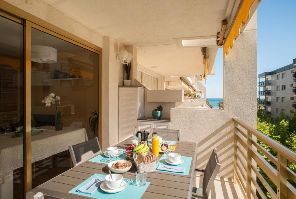 a balcony with a table with food on it at L'Eixideta in Salou
