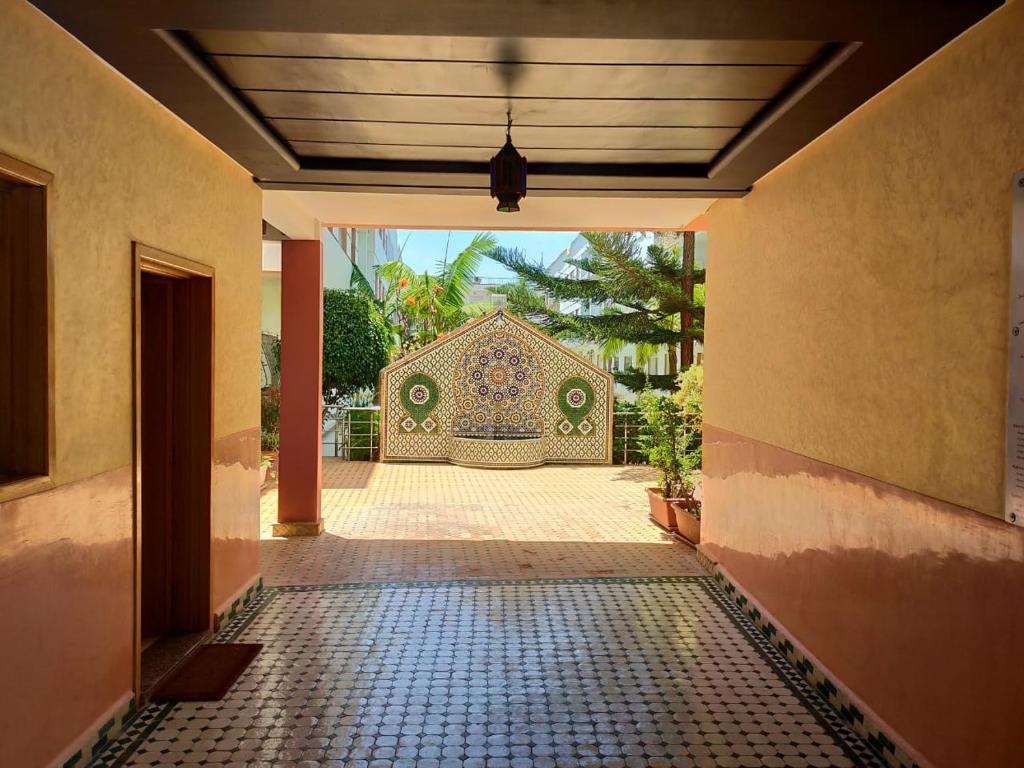 an entrance to a house with a tile walkway at apartment on the beach in El Harhoura