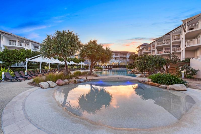 a swimming pool in the middle of a resort at Salt Beach Resort Private Apartments - Holiday Management in Kingscliff