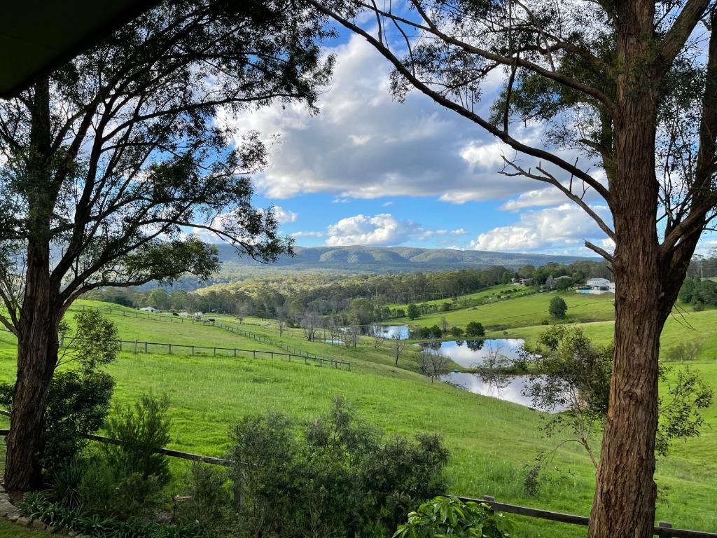 a view from the porch of a house with a view of a river at Tiny Home … BIG Views in Kurrajong