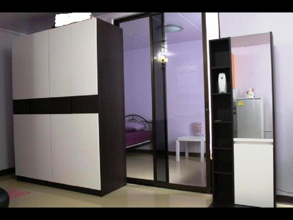 a room with a sliding glass door with a refrigerator at Room in Apartment - Popular Palace in Don Mueang Bangkok in Ban Bang Phang