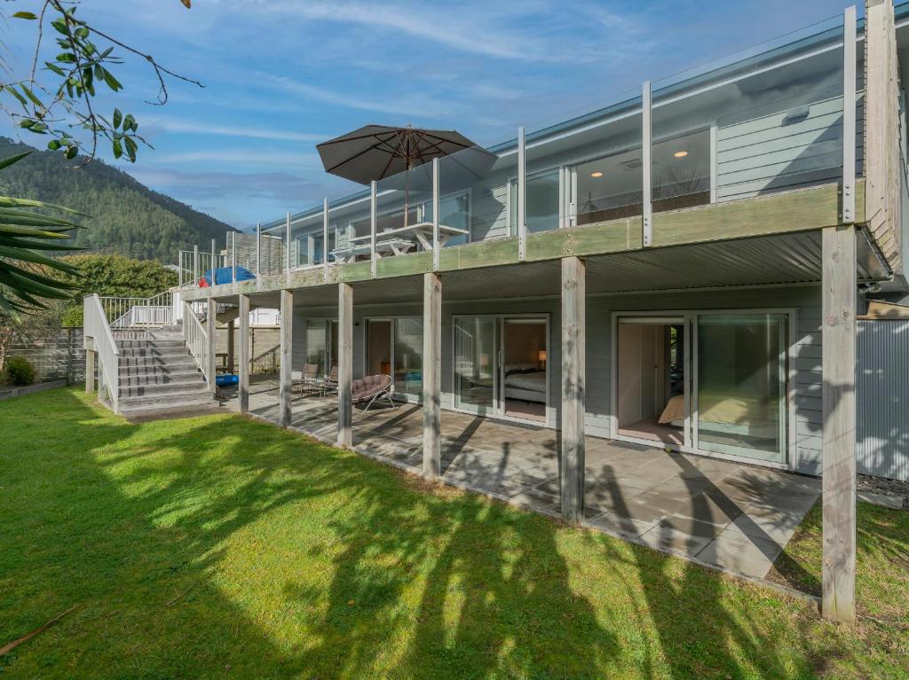 an exterior view of a house with a lawn at Bonanza Beauty - Pauanui Holiday Home in Pauanui