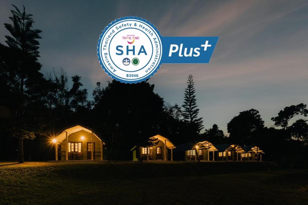 a sign that says shea plus in front of a row of houses at Phuket Campground in Mai Khao Beach