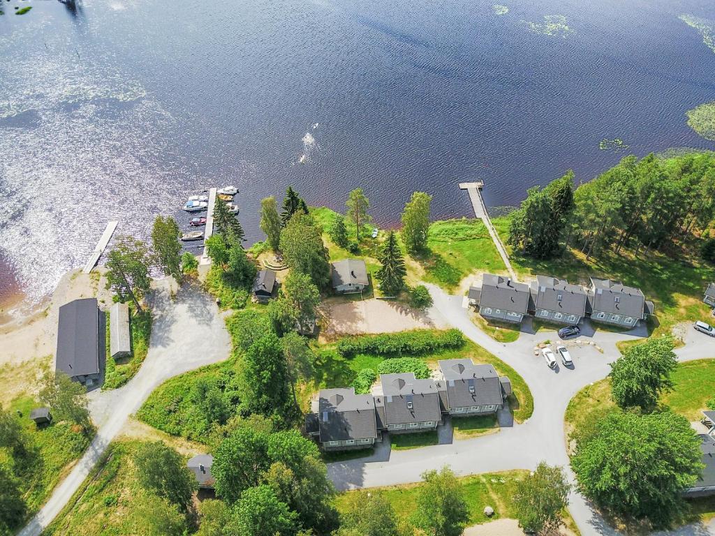 an aerial view of a house on the shore of the water at Marttinen in Virrat