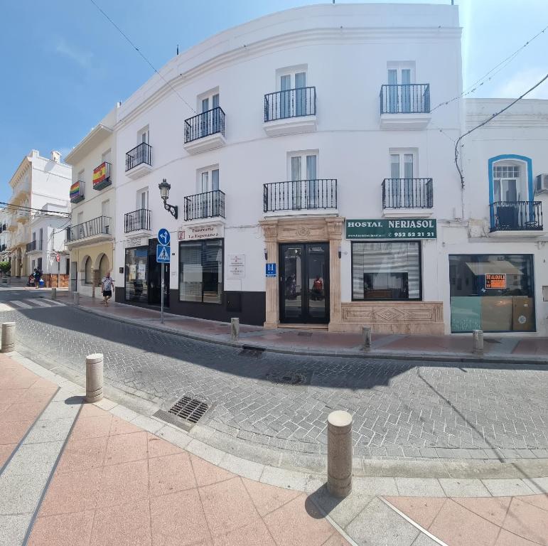 a street with a white building on a street at Hostal Nerjasol in Nerja