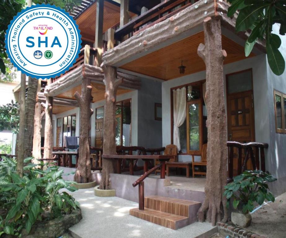 a house with a sign in front of it at Big Fish Resort Koh Tao in Koh Tao