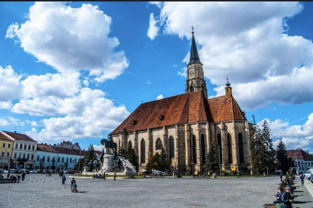 a large church with a steeple on top of it at The Historical Family House-Cluj Napoca center in Cluj-Napoca