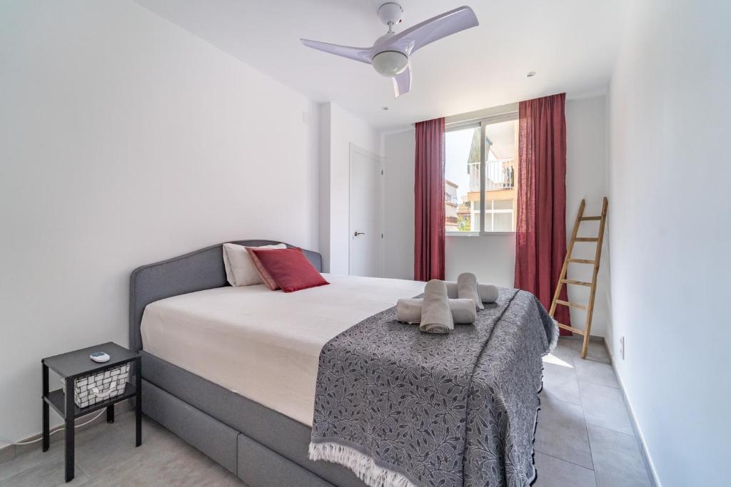 a small bedroom with a bed and a window at Myflats Premium Santa Pola in Santa Pola