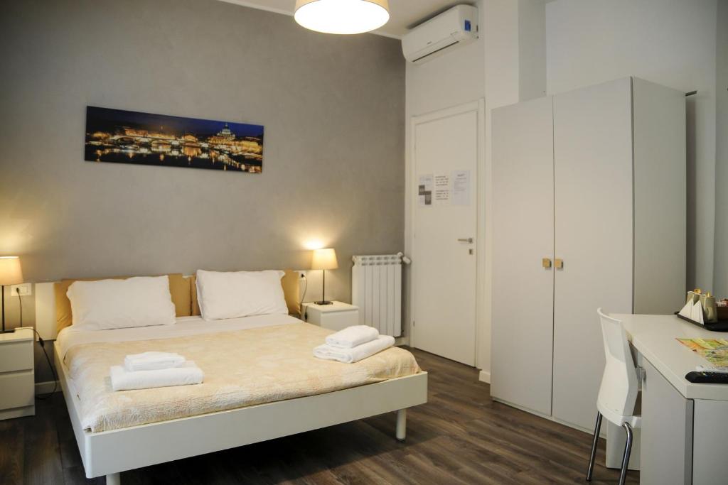 a bedroom with a bed with two towels on it at Infinity Castle in Rome