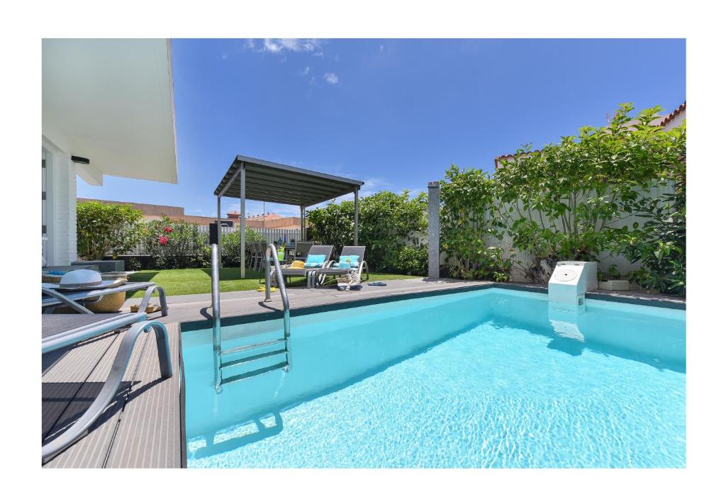 a swimming pool in the backyard of a house at Beach House Top ET 1 by VillaGranCanaria in San Agustin