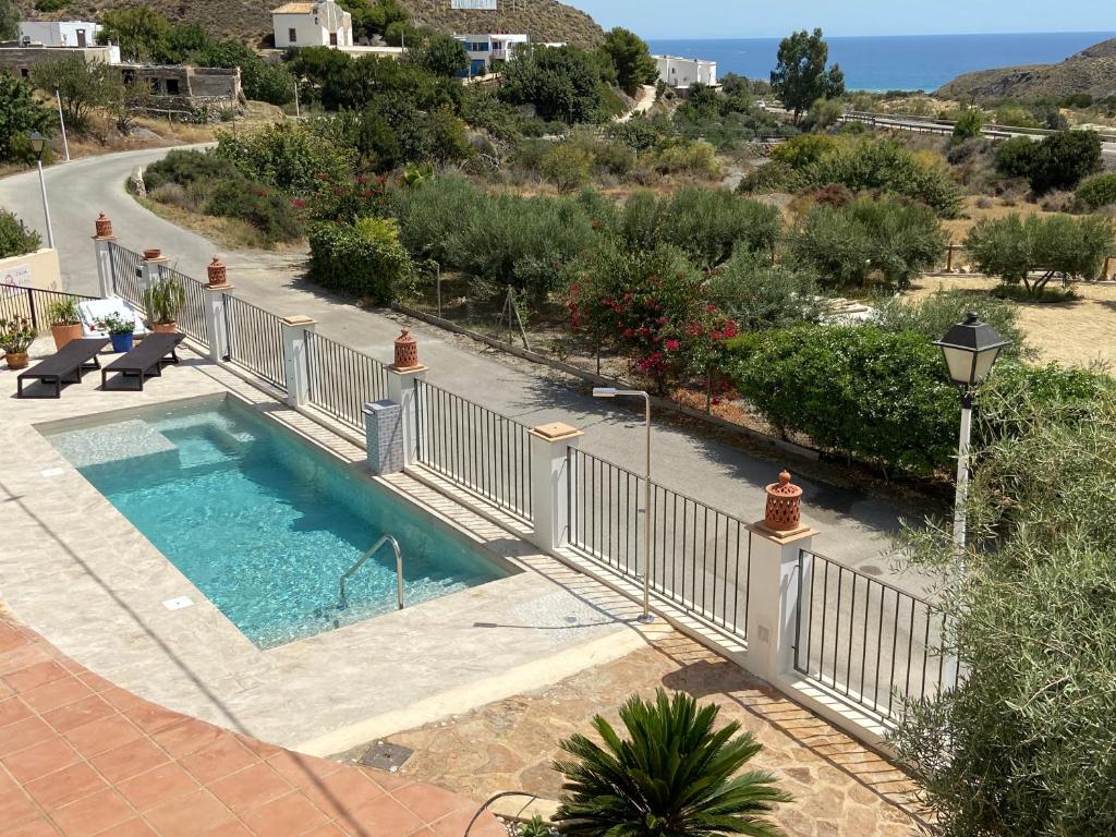 a swimming pool with a fence around it at Casa Rural Mi Abuela Maria in Mojácar