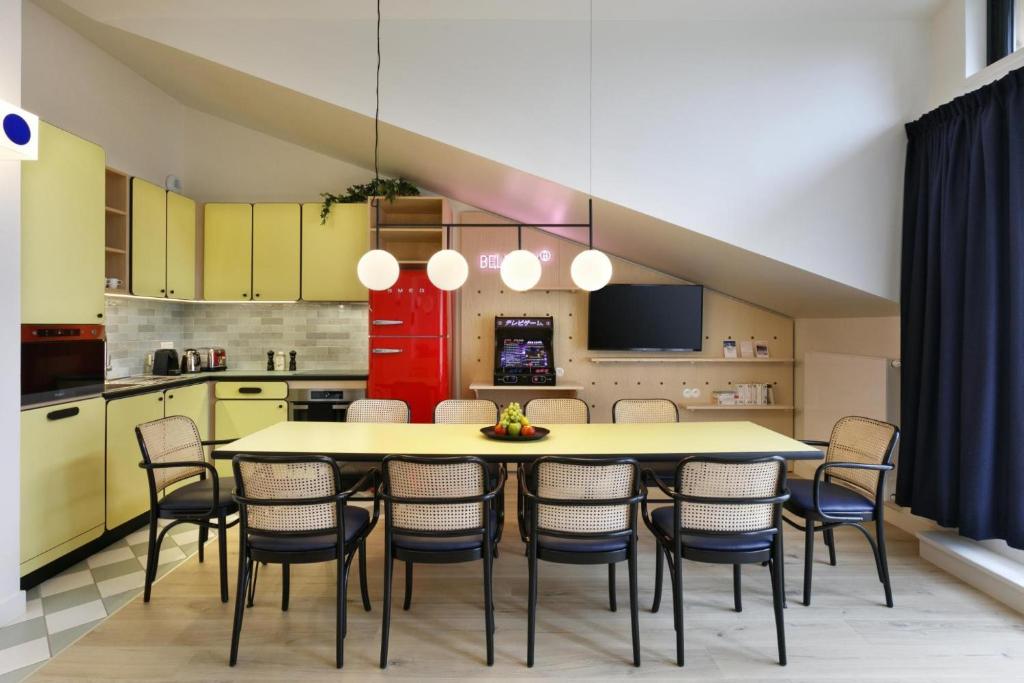 a kitchen with a dining room table and chairs at Appart'hôtel Bellamy Chamonix in Chamonix-Mont-Blanc