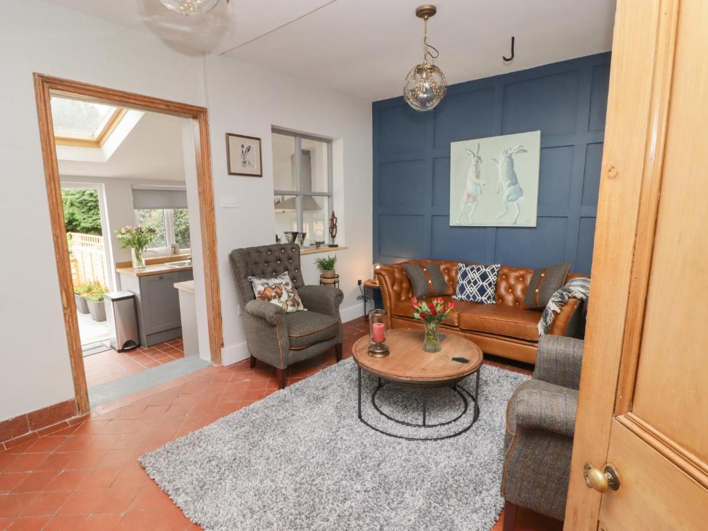 a living room with a couch and a table at 6 Castle Street in Craven Arms