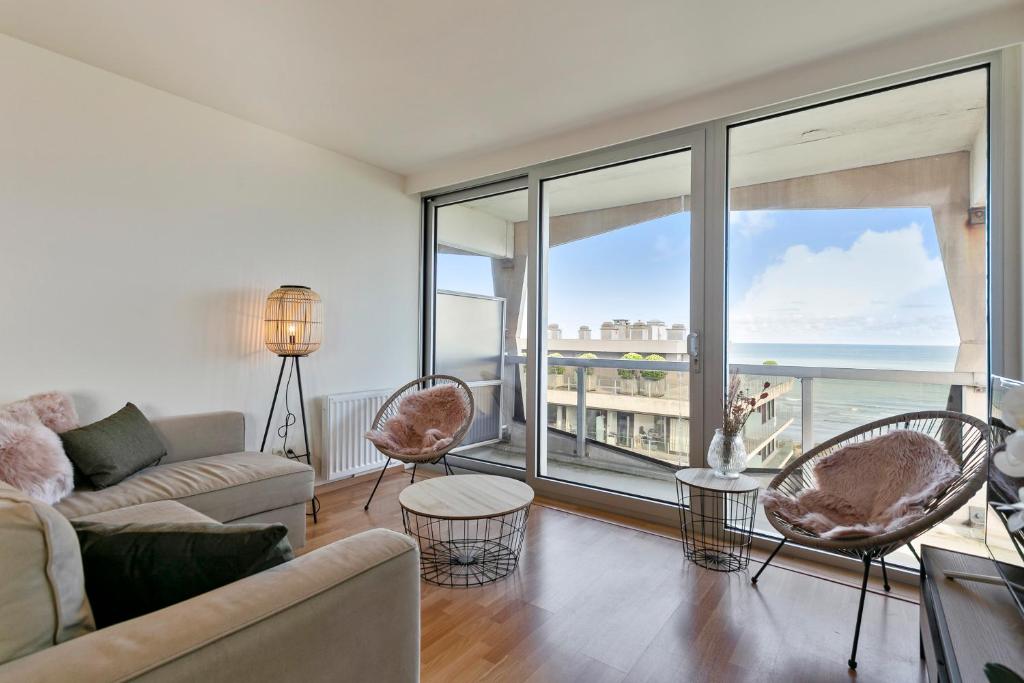 a living room with a view of the ocean at Flat Marie in De Panne